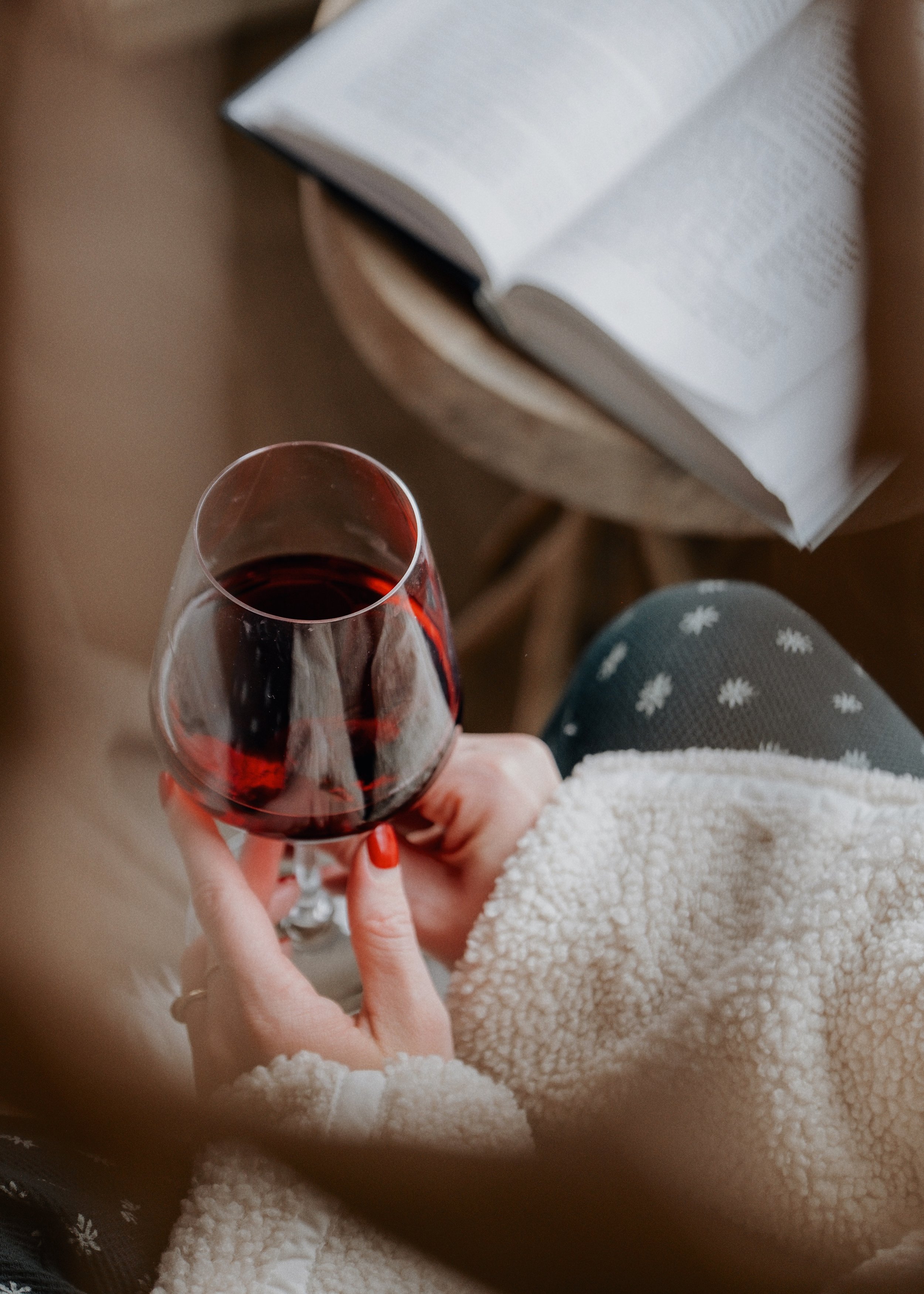 close up woman's hands holding wine glass