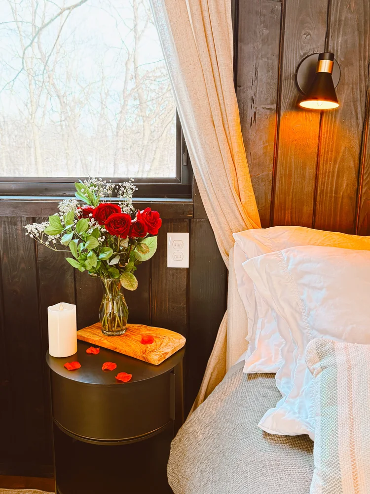 romantic roses on table with rose petals and candle